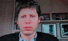 OpenAI CEO Sam Altman speaks remotely on a screen