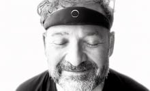 A man with the elemind headband, smiling with eyes closed