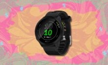 garmin forerunner 55 against a pink, yellow, and green patterned background