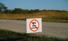 A sign stuck in the grass alongside a rural road. The sign reads "no data center."