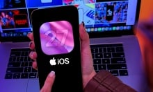 Apple iOS 27 logo on iPhone 17 Pro screen in person's hands