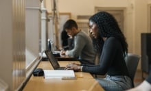 A woman works on her laptop.
