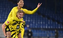 Dortmund's Norwegian forward Erling Braut Haaland celebrates with Dortmund's English midfielder Jude Bellingham (top) after the German first division Bundesliga football match FC Schalke 04 vs Borussia Dortmund in Gelsenkirchen, western Germany, on February 20, 2021