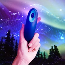 A person holding a Moonbird device against a starry sky.