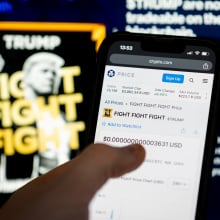 User buying $TRUMP on mobile device with memecoin website in the background
