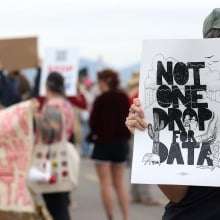 Demonstrators hold signs during a protest against the Project Blue data center in Tucson, Arizona