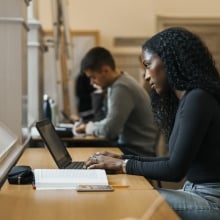 A woman works on her laptop.