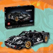 lego technic 1966 ford gt40 mkii race car set against an orange and blue patterned background