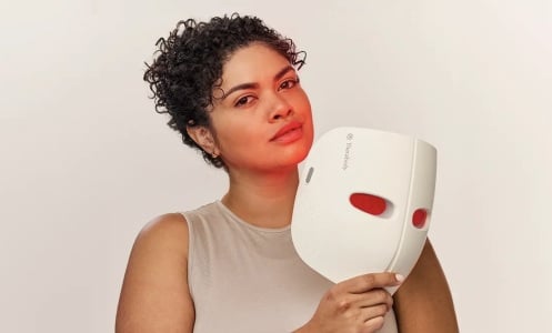 person holding theraface mask 