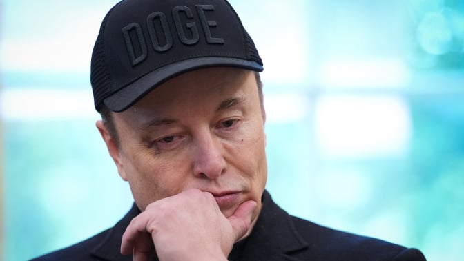 Elon Musk wearing a DOGE cap