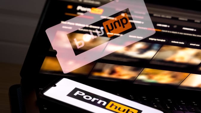 pornhub logo on phone and blurred site on screen