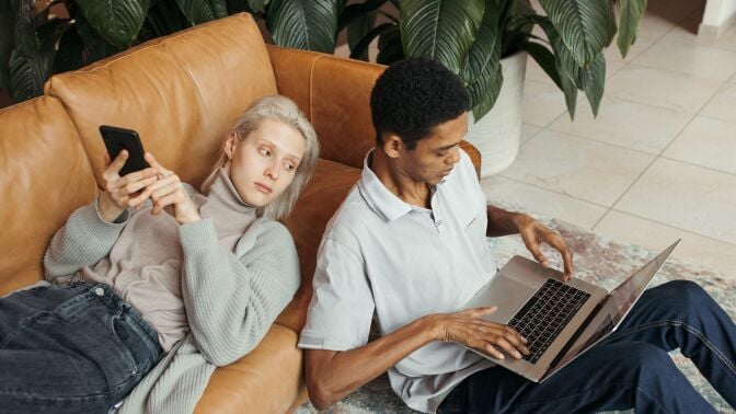 Couple staring at laptop