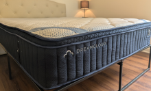 the dreamcloud premier hybrid mattress in a bedroom with no sheets