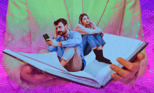 A man and woman sit inside the open pages of a book, the man turns his back on the woman while he stares at is phone. 