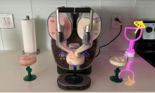 Ninja Slushi Twist after making strawberry and pineapple frosé, two margarita glasses, and a neon light on kitchen countertop