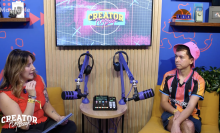 A man and a woman talking into podcast mics in a studio 